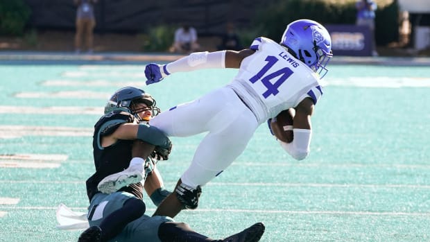 Nov 13, 2021; Conway, South Carolina, USA; Coastal Carolina Chanticleers cornerback Alex Spillum (10) tackles Georgia State Panthers Robert Lewis (14) at Brooks Stadium. Mandatory Credit: David Yeazell-USA TODAY Sports